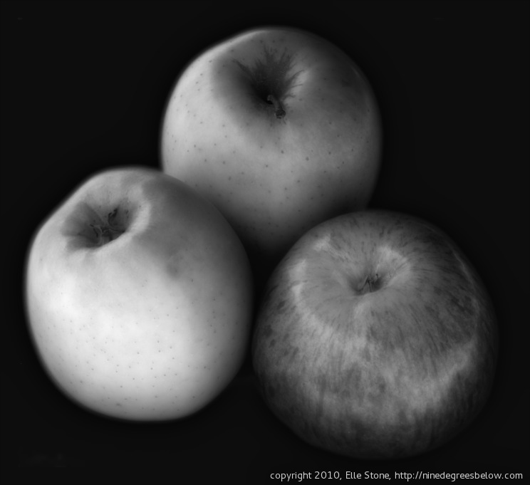 Three apples against a dark background.